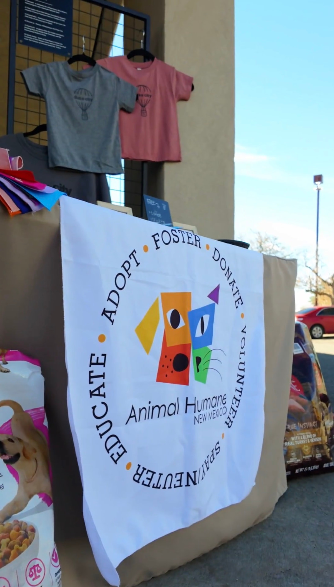 Animal Humane New Mexico banner displayed at a Better with Baron donation drive in Albuquerque