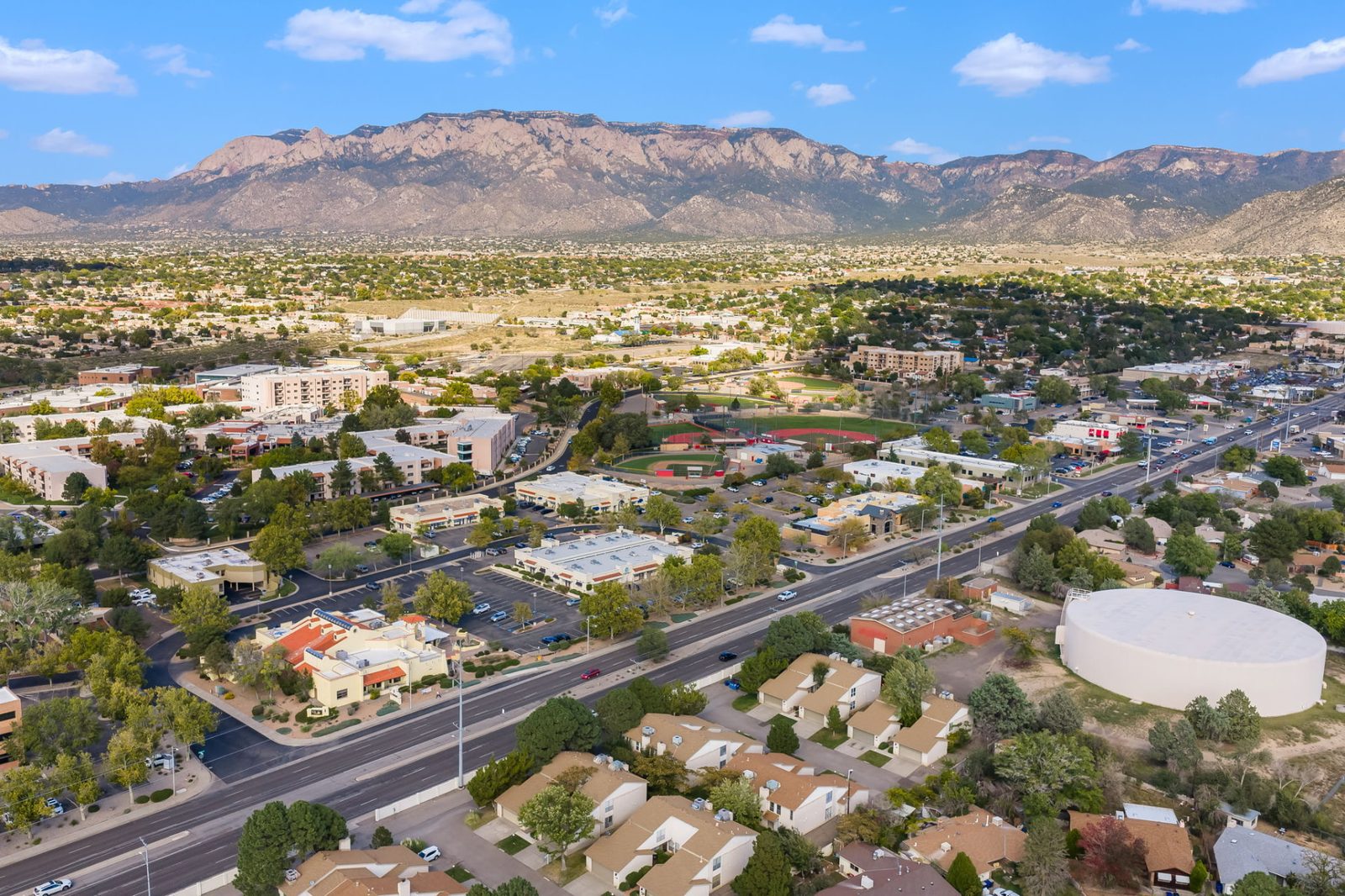 Aerial view of the Northeast Heights in Albuquerque, NM, with the Sandia and Manzano Mountains spanning the horizon.