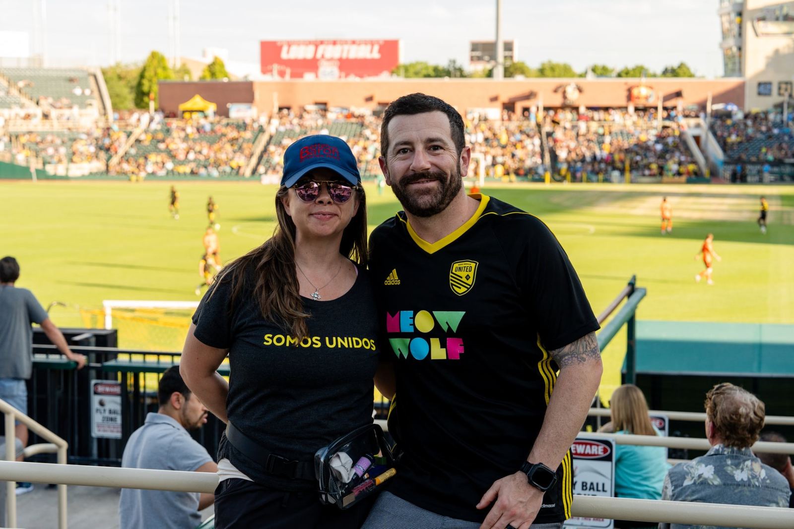 Albuquerque homeowners in New Mexico United jerseys at a Better with Baron client appreciation soccer night.