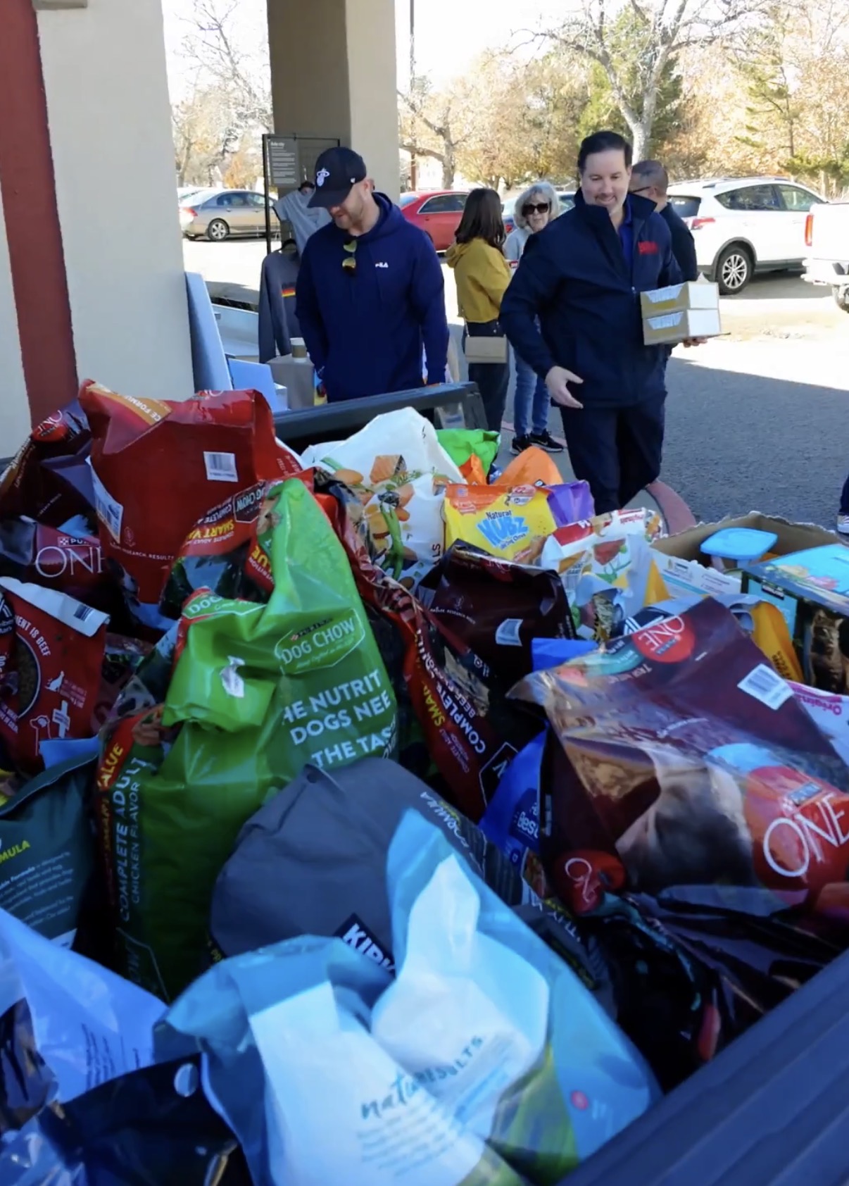Volunteers sorting donated pet food at a Better with Baron community donation drive