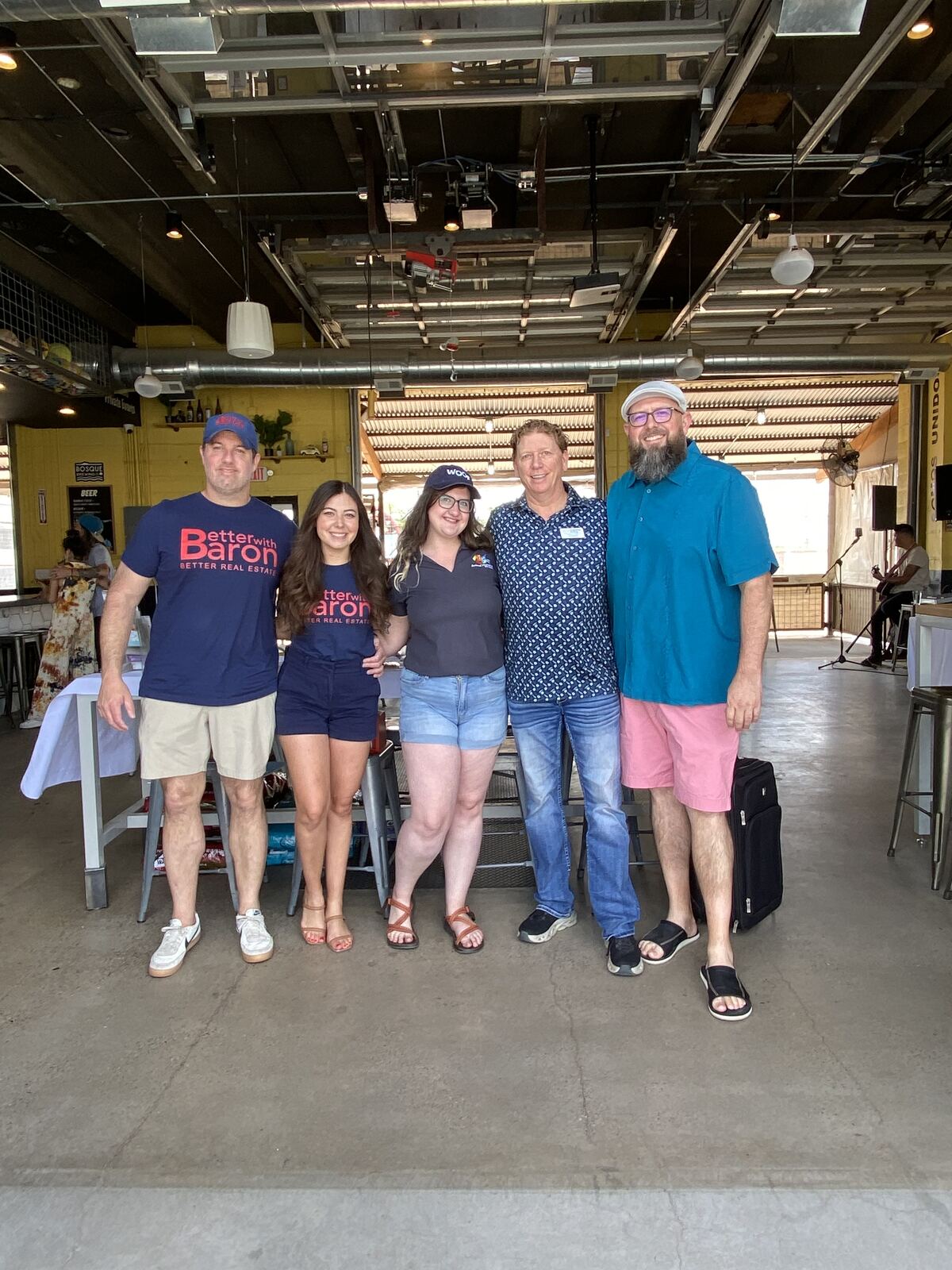 Better with Baron real estate team in branded shirts at the annual Baron Bash client appreciation party at Duke City Beaches in Albuquerque, New Mexico