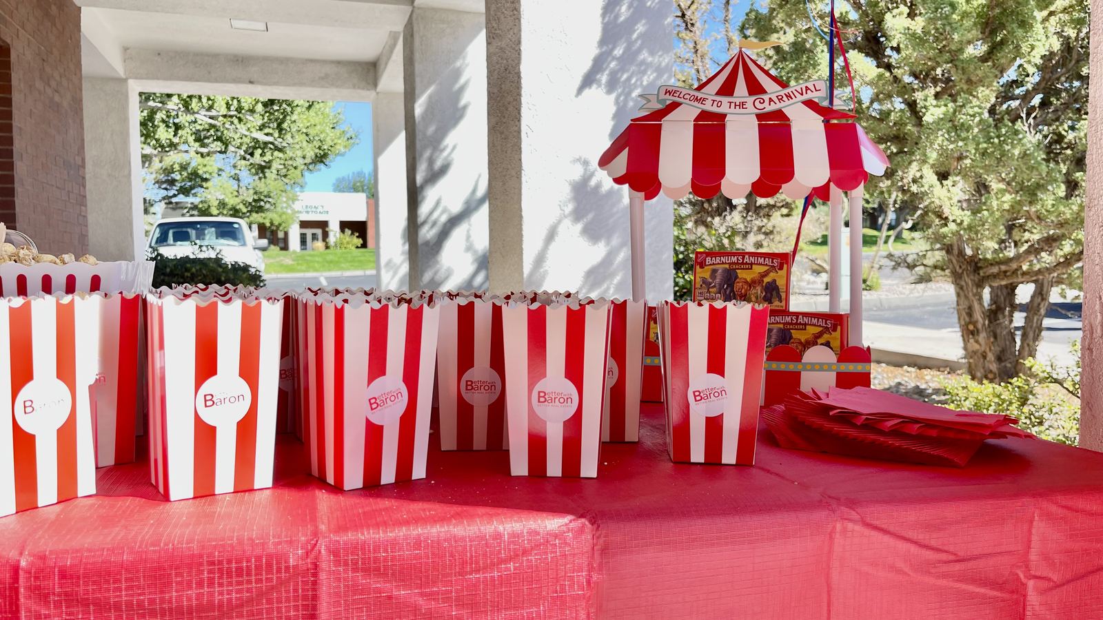 Better with Baron branded popcorn boxes and a carnival tent at a community client appreciation carnival in Albuquerque
