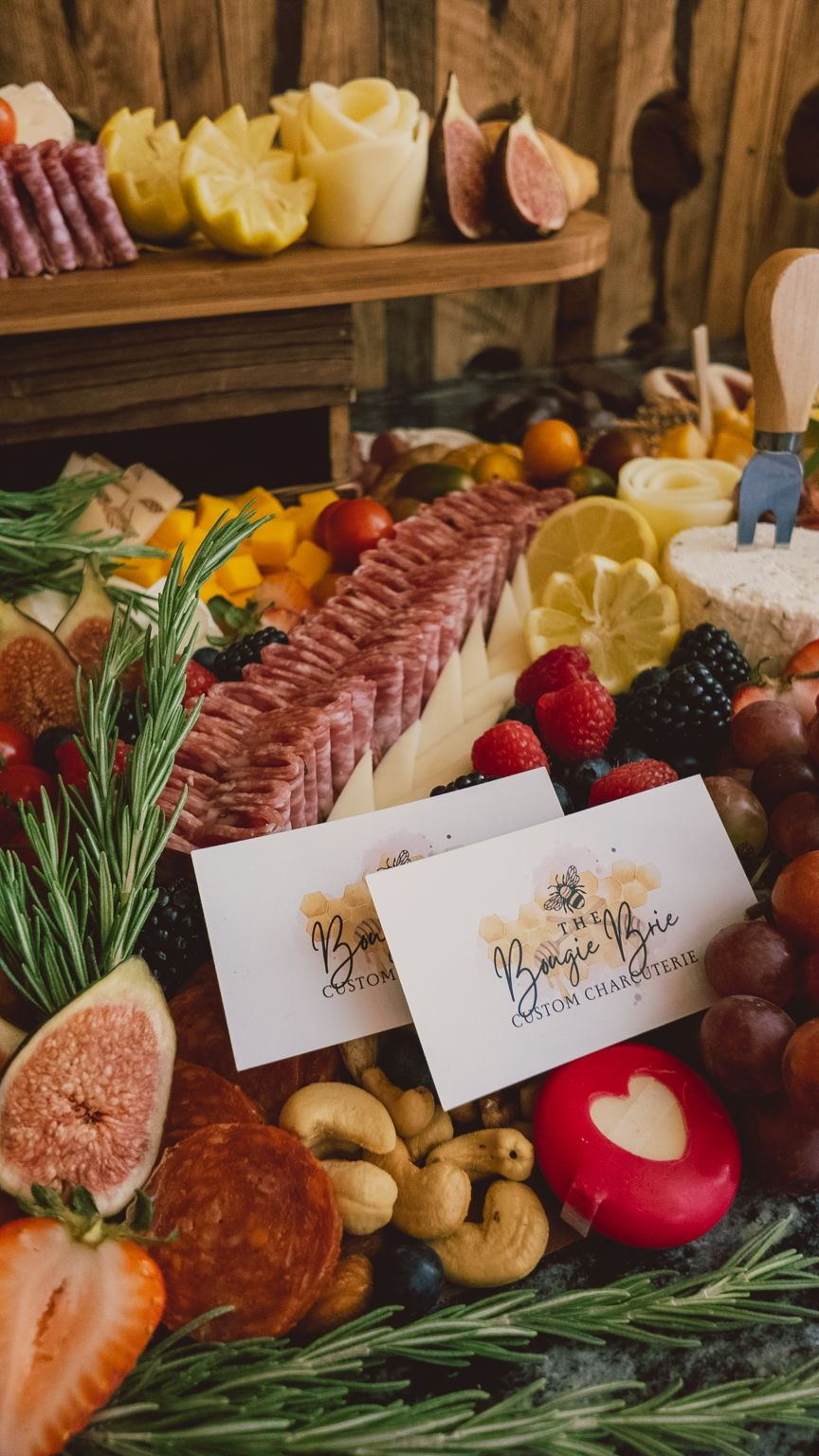 Close-up of a Boujie Brie custom charcuterie board with salami, figs, and berries at a Better with Baron client gathering in Albuquerque.