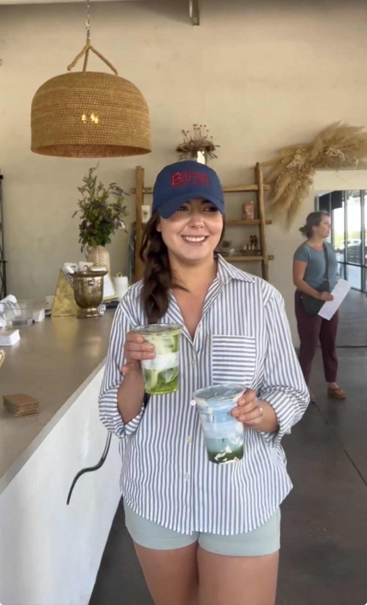 Better with Baron team member holding iced drinks from a local Albuquerque coffee shop