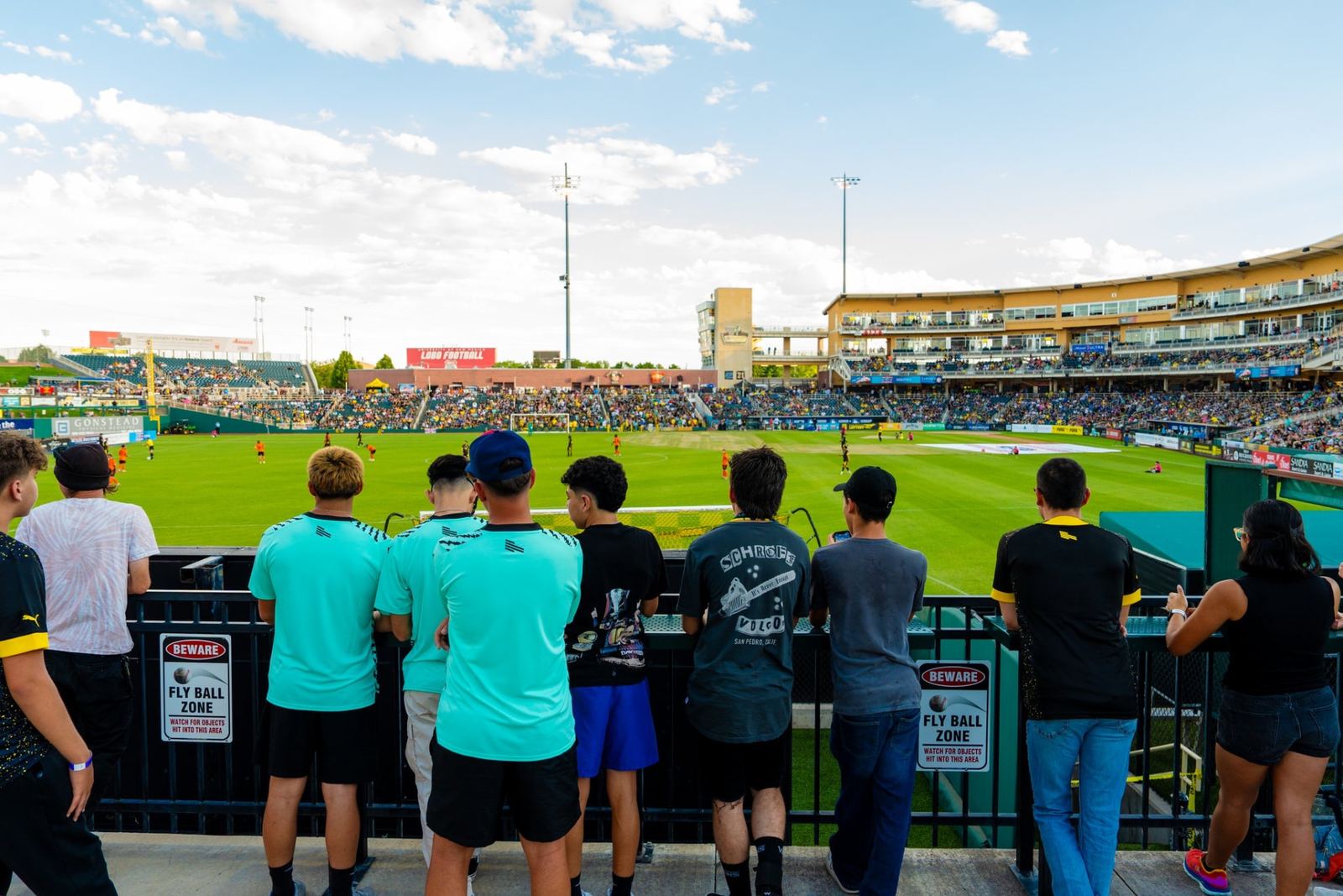 Fans lined along the outfield rail at Isotopes Park during a Better with Baron client appreciation night in Albuquerque.