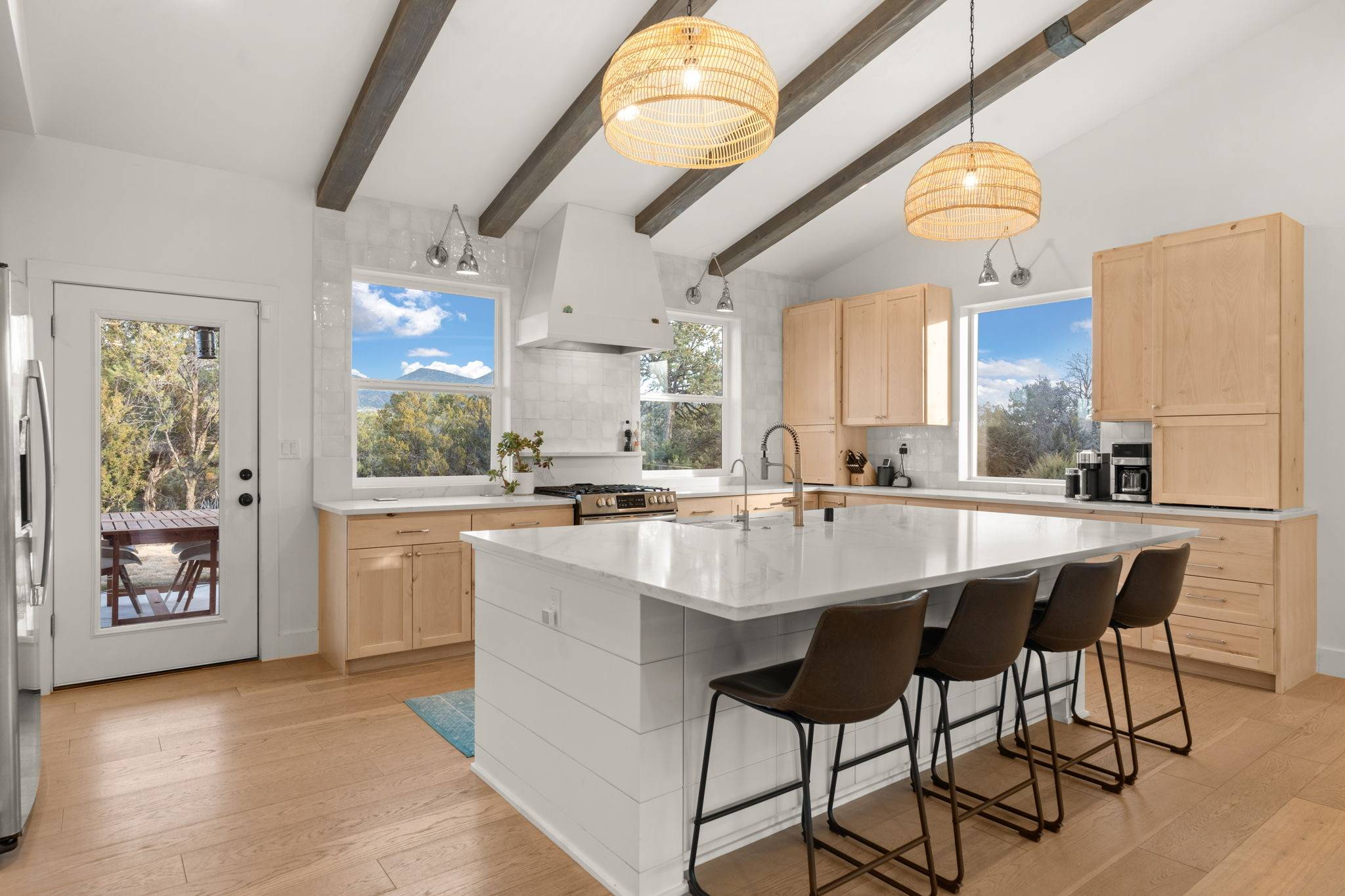 Beautifully redone kitchen with an open concept. White island with a sink and shaker oak cabinets. Albuquerque, NM. Better with Baron Real Estate Team.