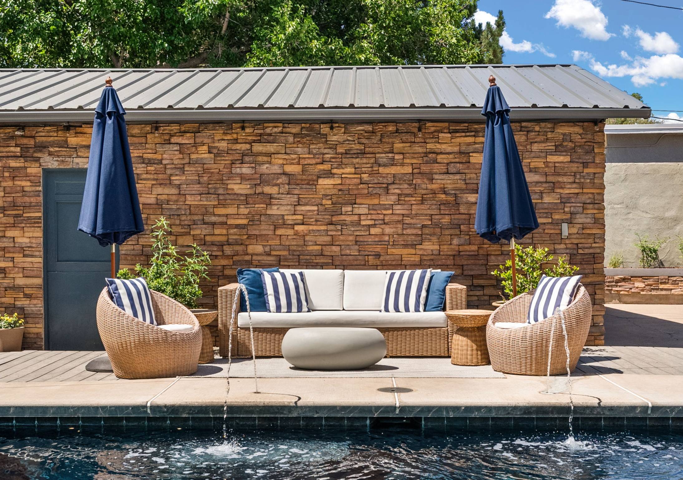 Home with a pool and modern patio furniture. Pool Add Value to Albuquerque Homes