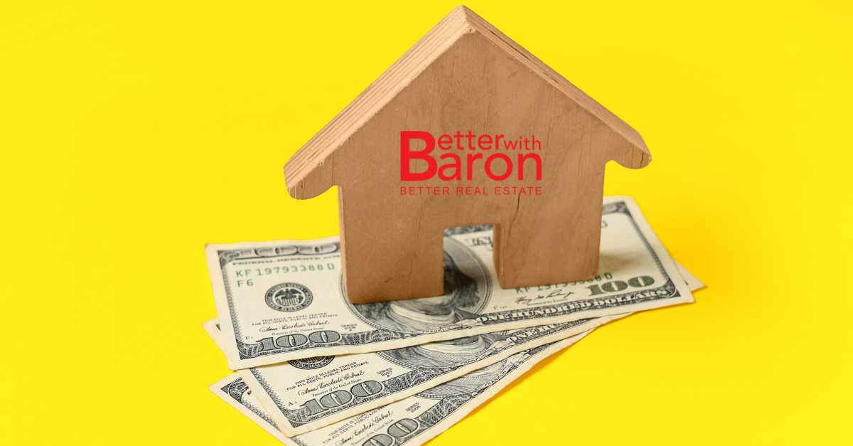 A small wooden home with the Better with Baron logo on top of three 100 dollar bills underneath. Seller financing Albuquerque.
