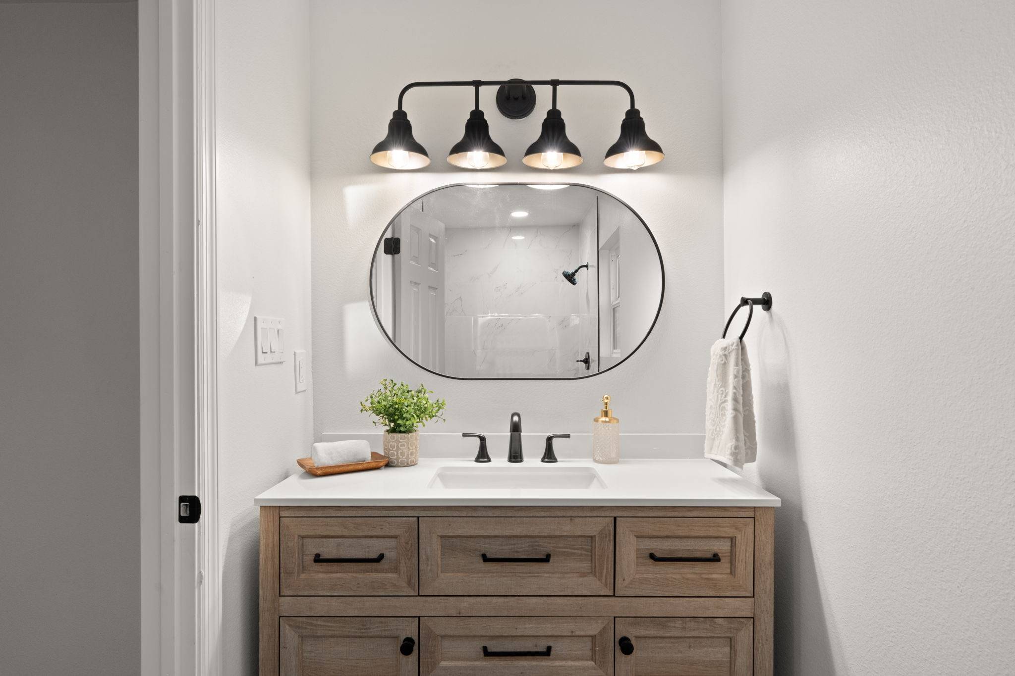 A beautifully renovated bathroom vanity with black accents and fixtures. Renovations that add value in Albuquerque.