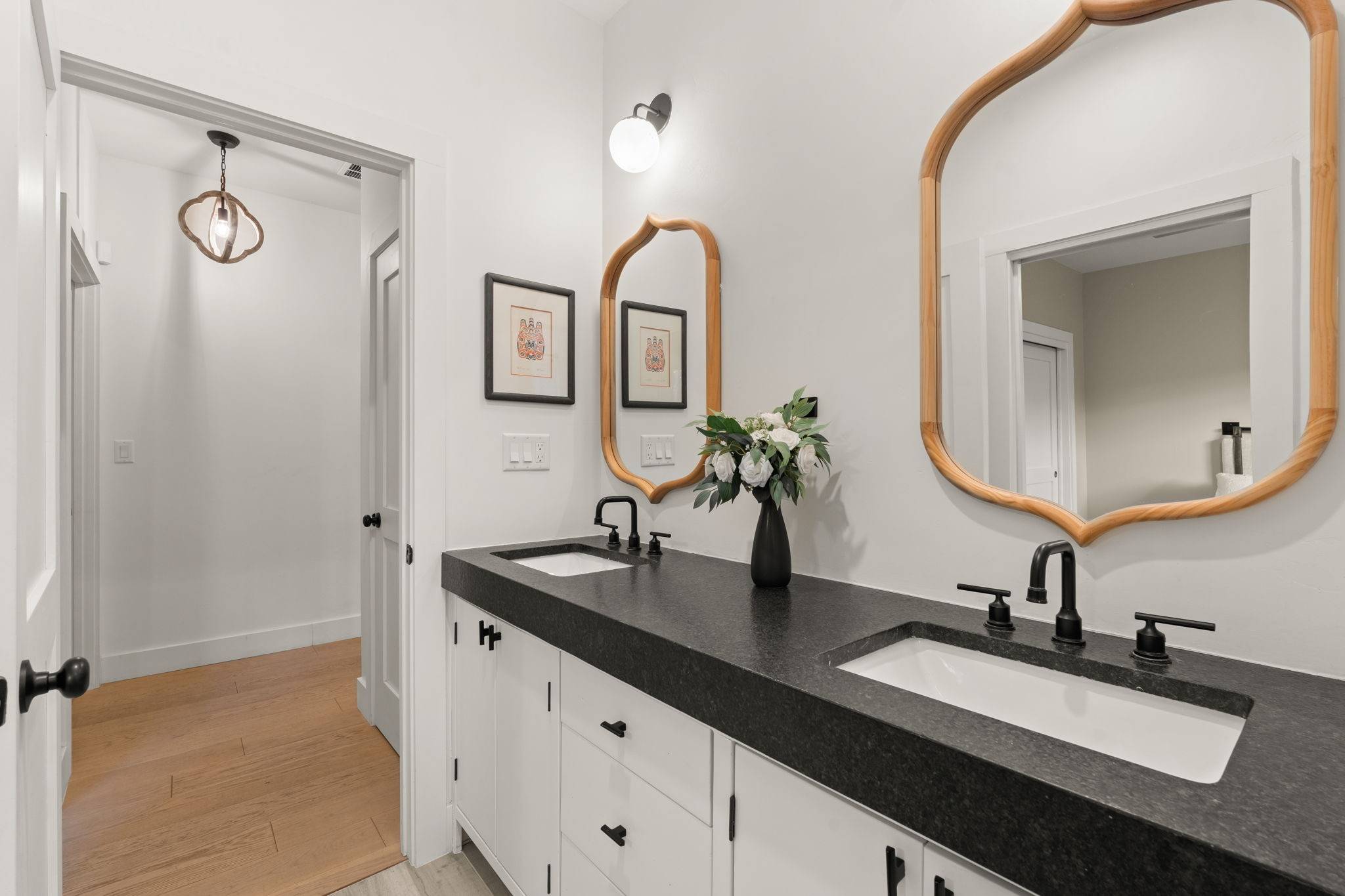 Cosmetic vs Structural Renovations in Albuquerque Homes. Beautifully newly redone bathroom with thick black counter tops. Home listed by Better with Baron real estate team in New Mexico.